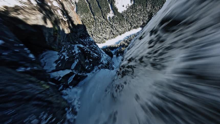 A speed dive down a snow covered mountain side