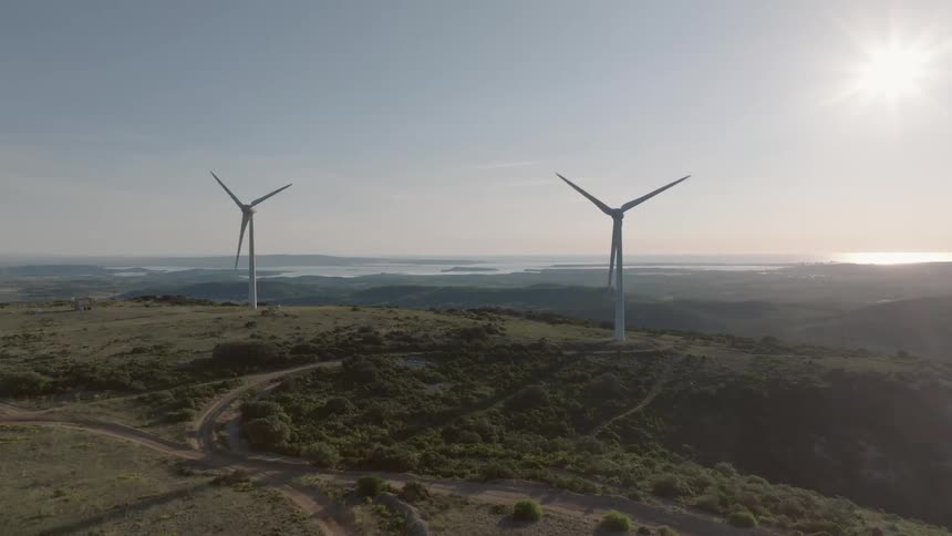 The sun is shining on the windmills