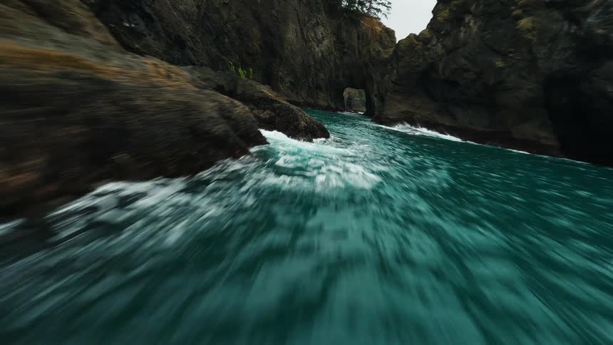 Aerial of a rocky coastal area with flowing sea water during daytime