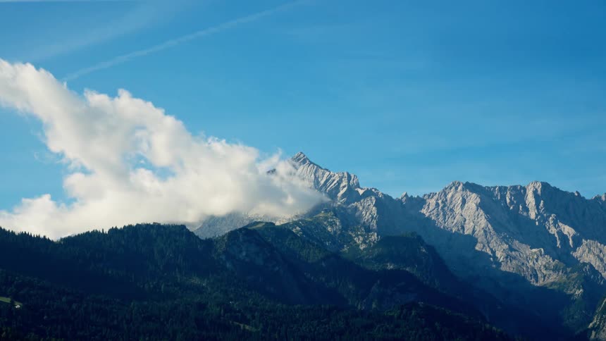 A cloud bank over the peaks of a mountain range
