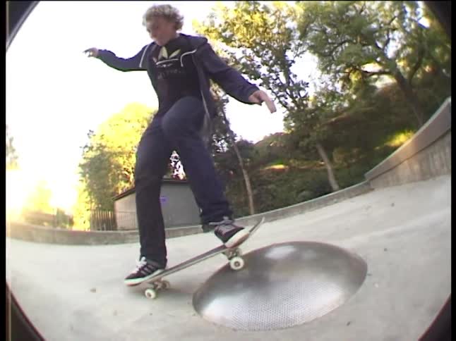 A kid rides his skateboard
