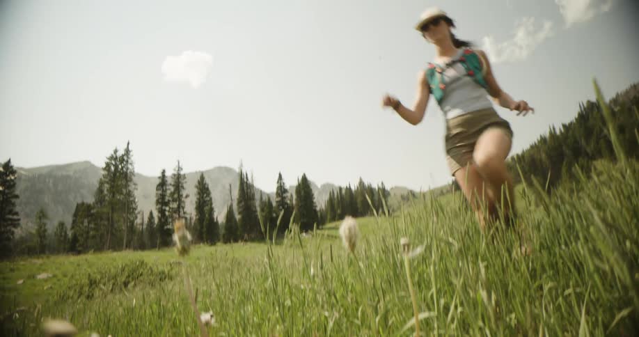 The woman is running through the grass
