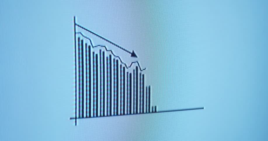 The animated data graph steadily goes down with a negative trend or declining tendency on the pixelated monitor presenting a financial or business statistic during a cooperate presentation with a holographic overlay or effect