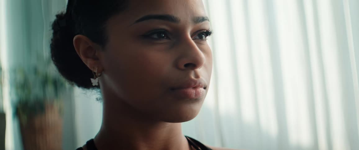 The woman takes a deep breath with her eyes closed