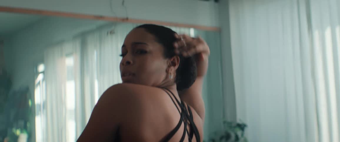 Young Black Woman in black dress dancing in a ballroom
