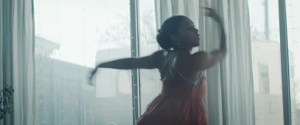 Black woman kicks her leg high while dancing