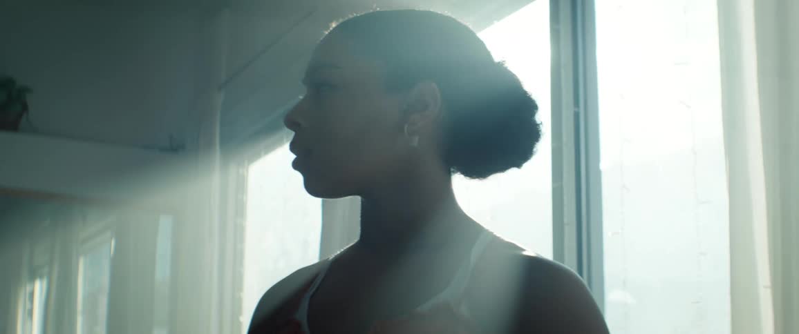 Confident Empowered Woman in profile with Serious Facial Expression in a naturally lit room next to a window