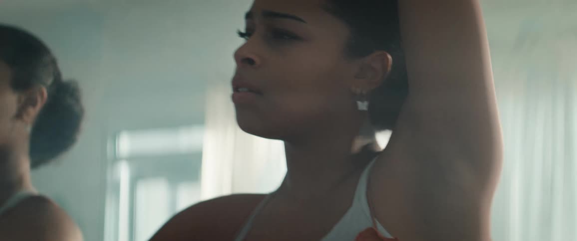 The woman dances and leans against the mirror