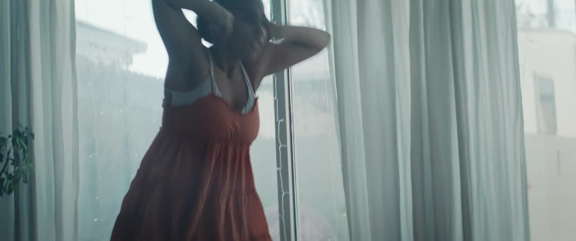 The woman spins and her dress flows as she dances