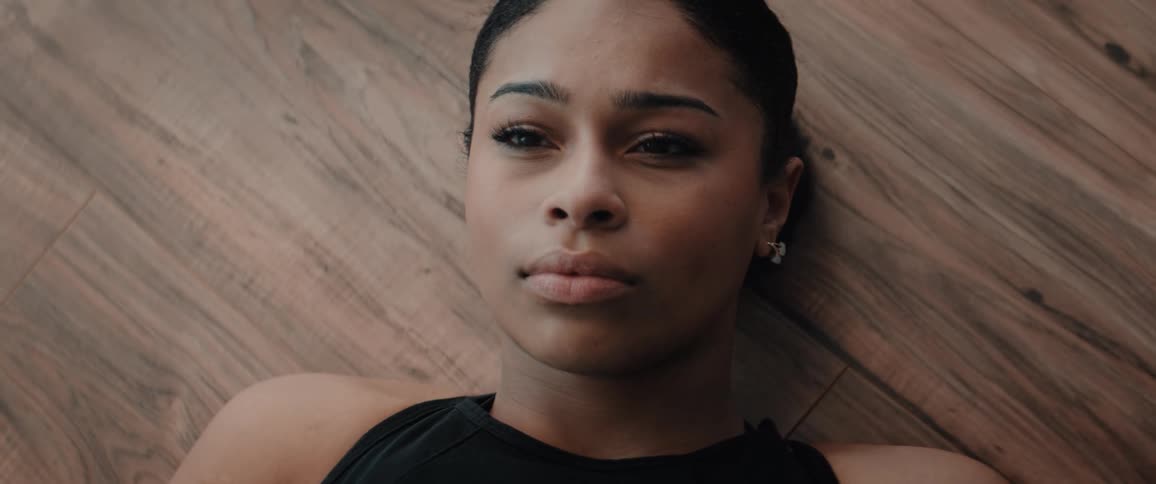 The serious woman is deep breathing with a determined facial expression