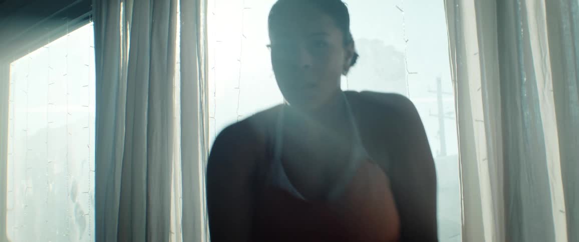 Ballerina in motion beside a window lit by natural light