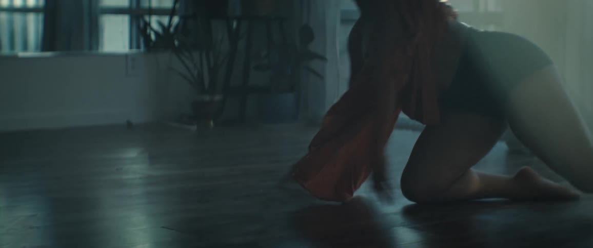 The woman comes out of a handstand dancing