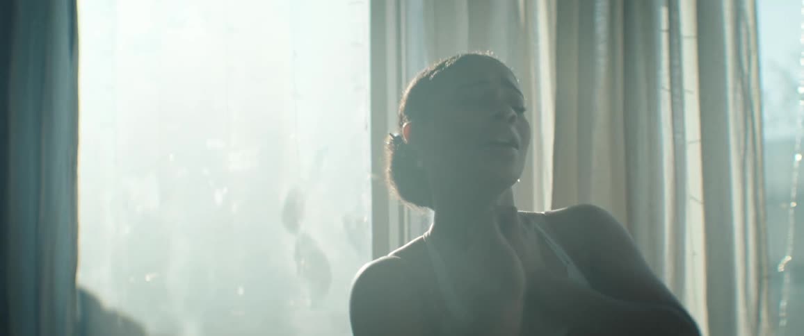 The woman smiles while dancing in the room