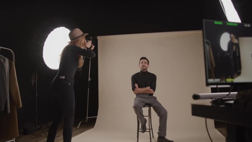 The photographer gets in close with the camera to photograph the model