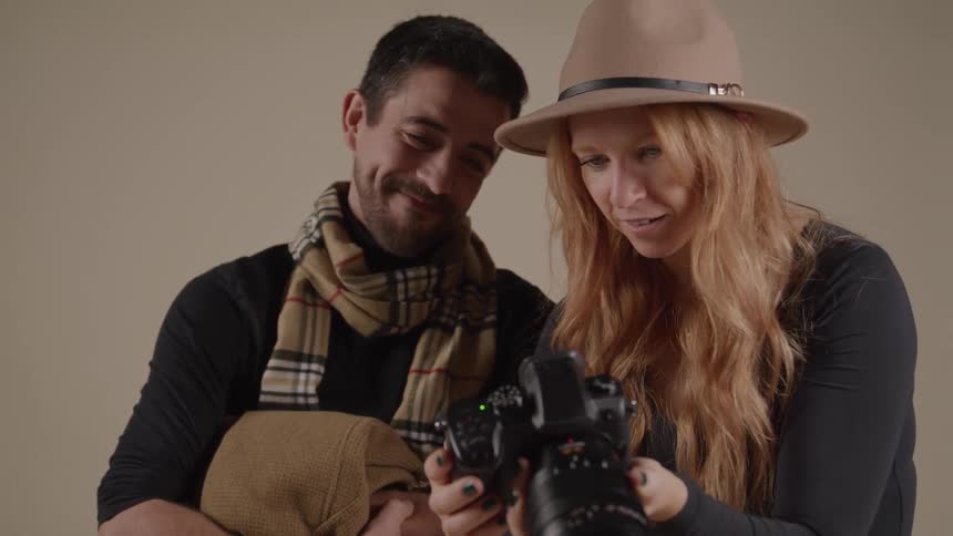 Woman shows the result to the man who watches smiling by her side