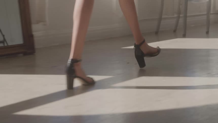 A woman walks in high heels