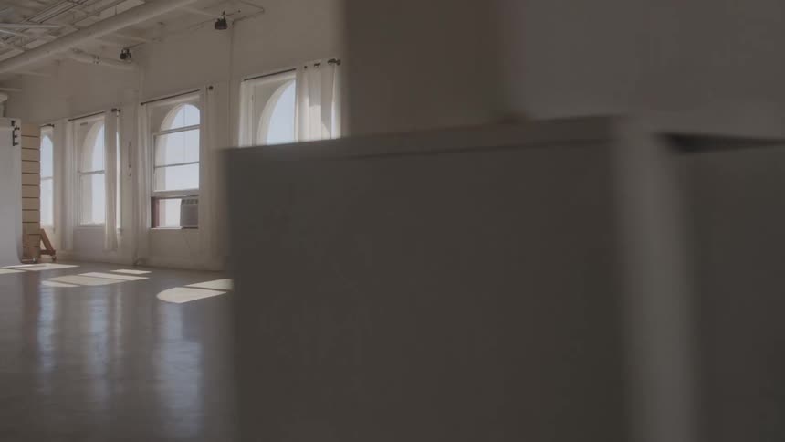 A woman walks in a large room