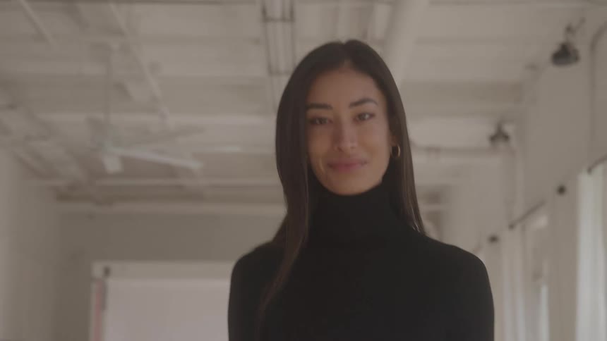Woman walks confidently in a bright indoor setting