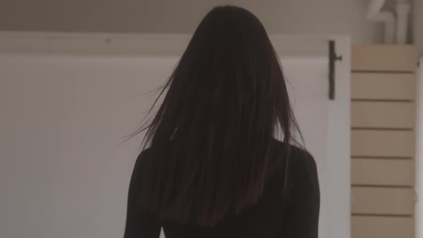 A woman in black walking