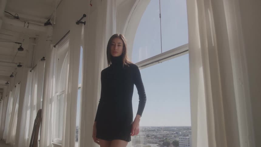 The woman is modeling in a black dress