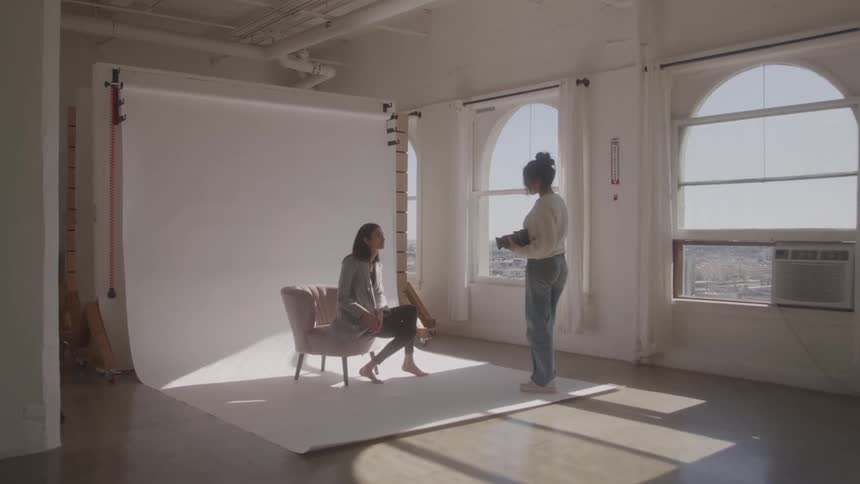The photographer is talking with the model