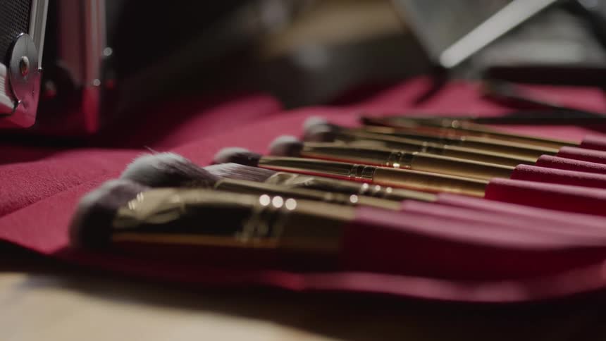 Close up of a set of makeup brushes arranged together on a table