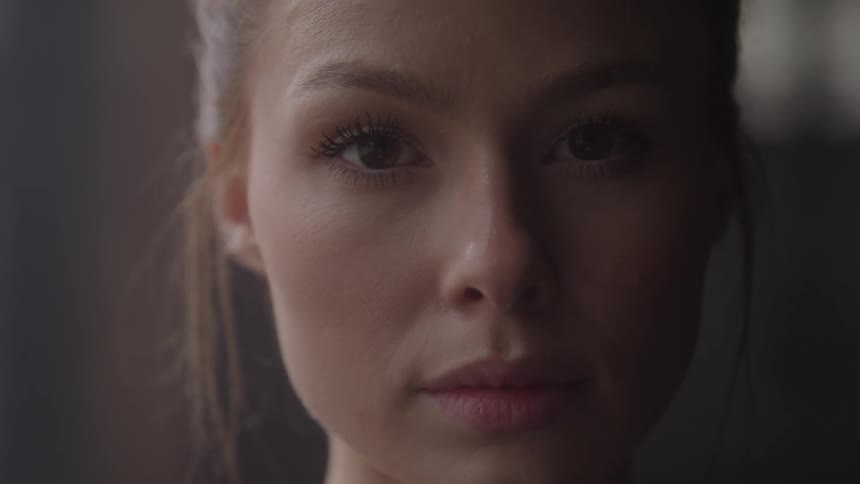 Close up portrait of a young woman in a room