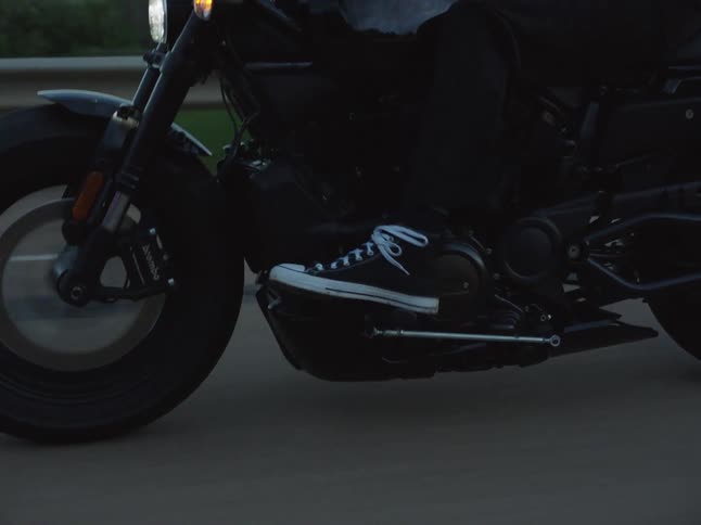 Closeup of the motorcyclists feet on the pedals while riding