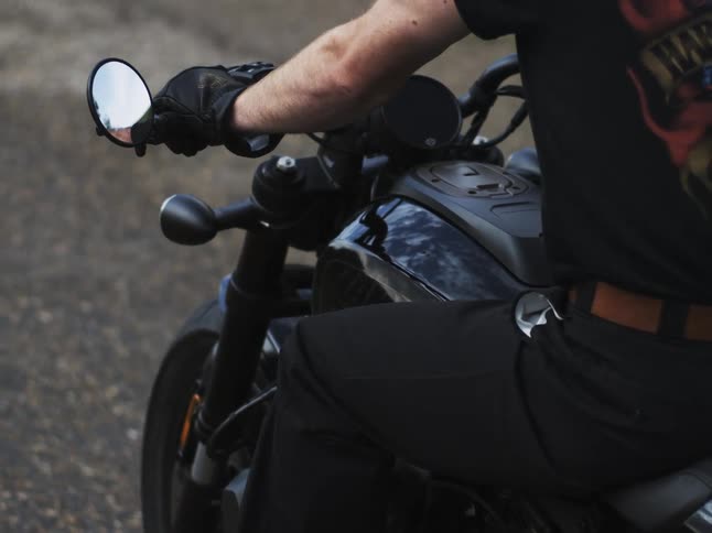 The man rides on his motorcycle on the road