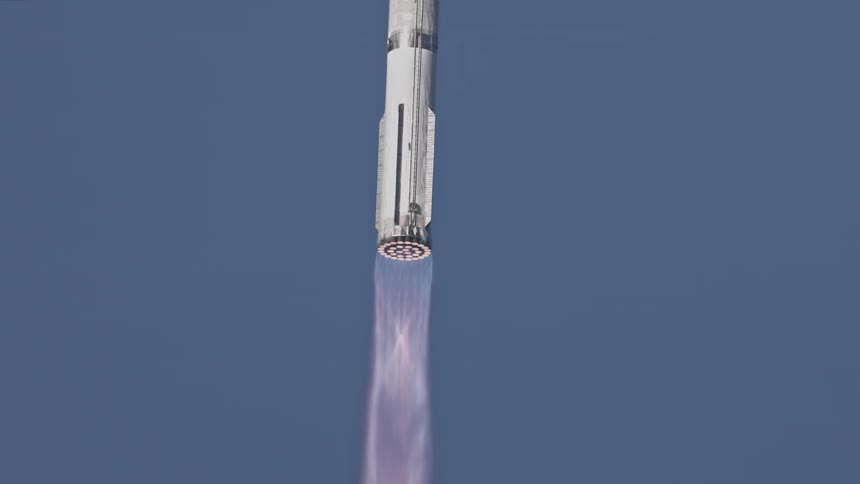 A rocket shoots straight up in the clear sky