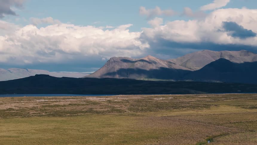 A large lake is before the mountain