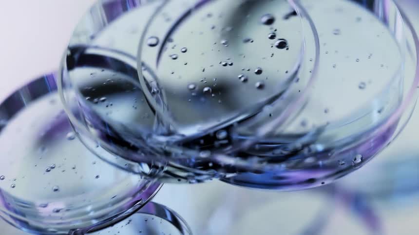 Rings float gently inside a liquid moving in a slow animated motion