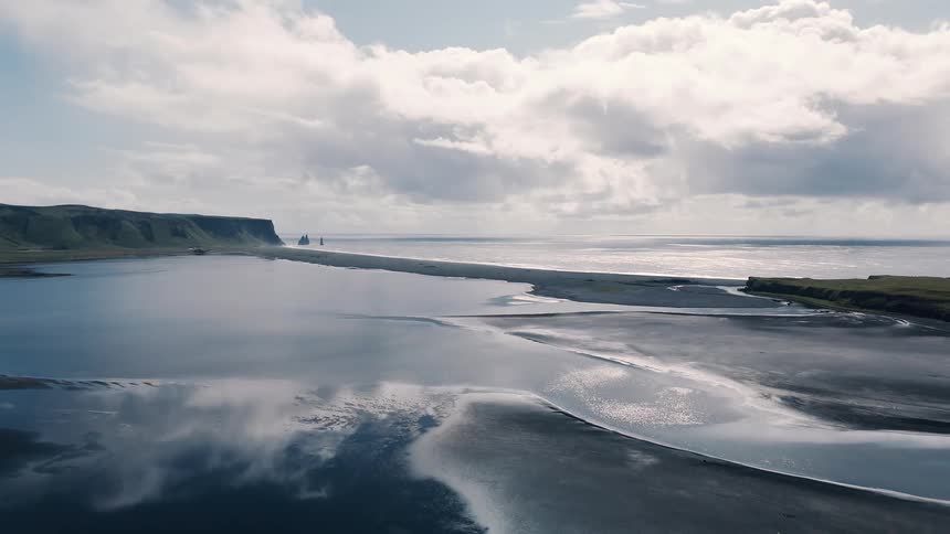 Beach surrounded by coastal landforms outdoors during day time