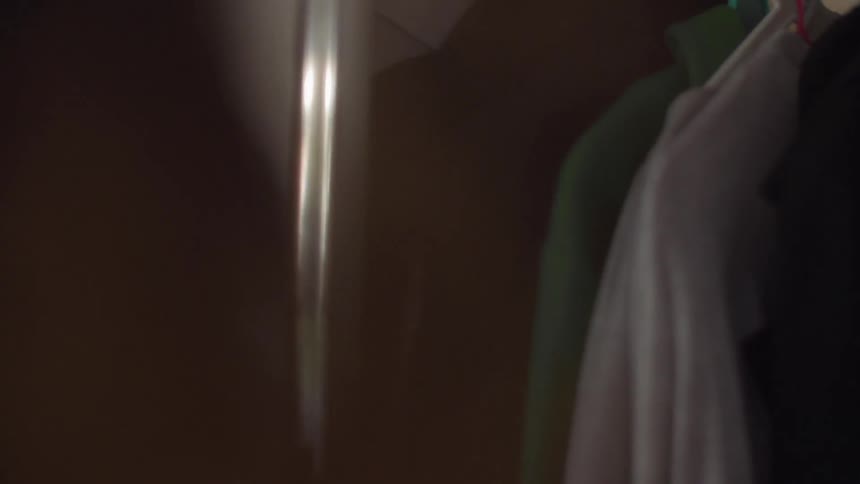 Woman slides a mirrored door open