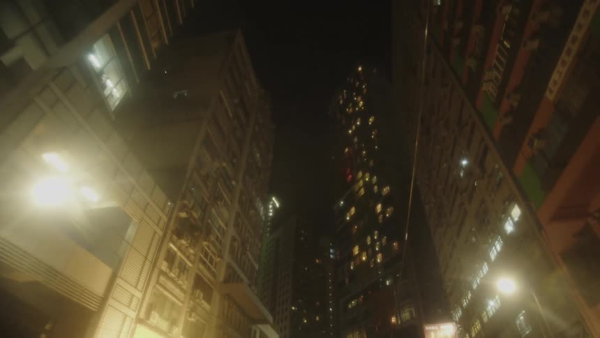 Densely packed city skyline with modern high rise buildings at night