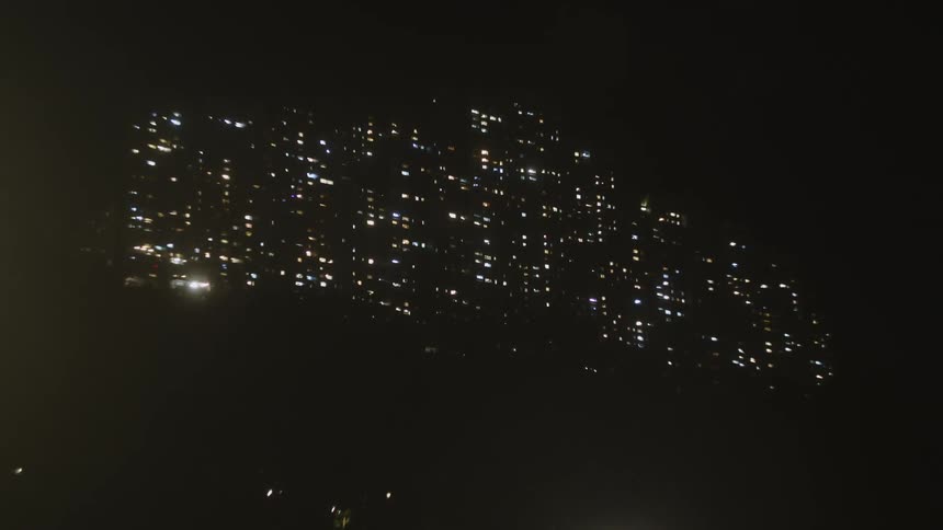 Scattered lights illuminate the hillside during the night