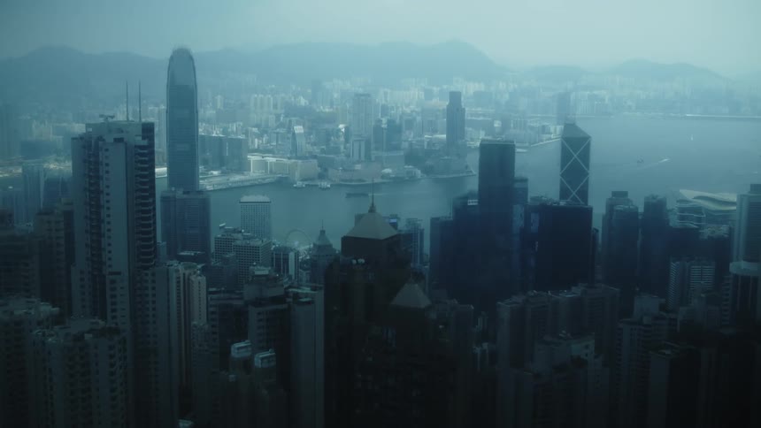 Aerial view of a dense city skyline with tall skyscrapers by the waterfront