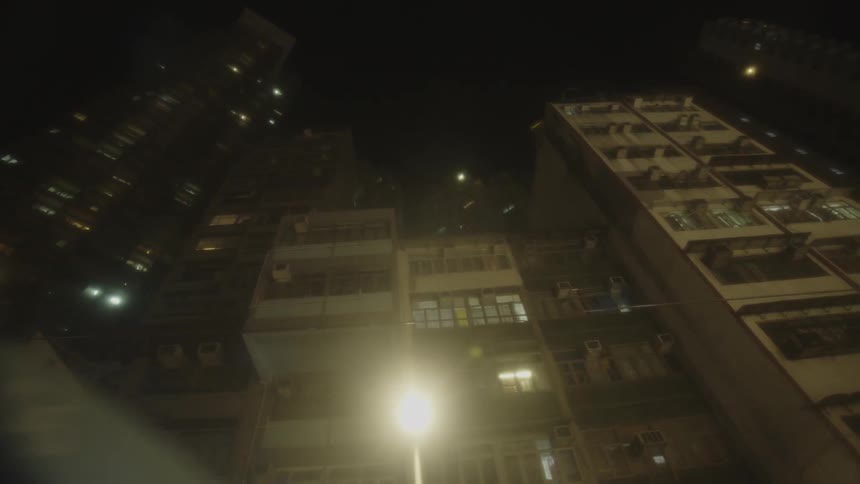 Tall apartment buildings with glowing windows at night