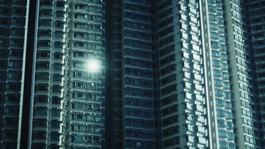A stationary medium view focusing on the surface of a large vertically repeating structure composed of rows of square windows