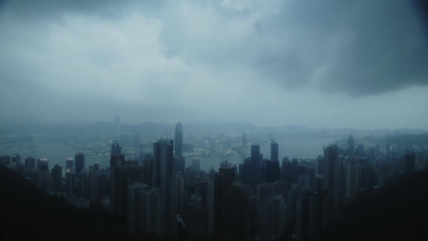 Urban landscape with skyscrapers under a cloudy sky by the edge of a bay