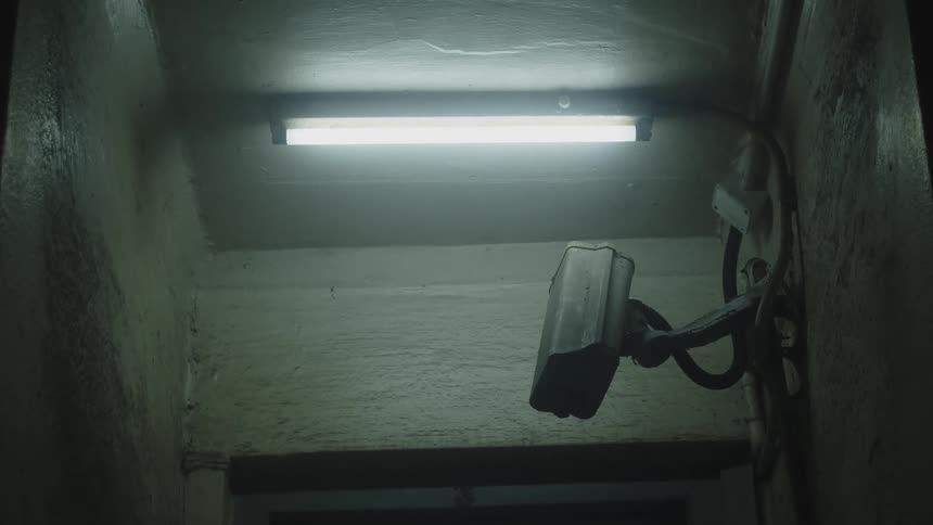 Security camera installed under cold light in an indoor setting