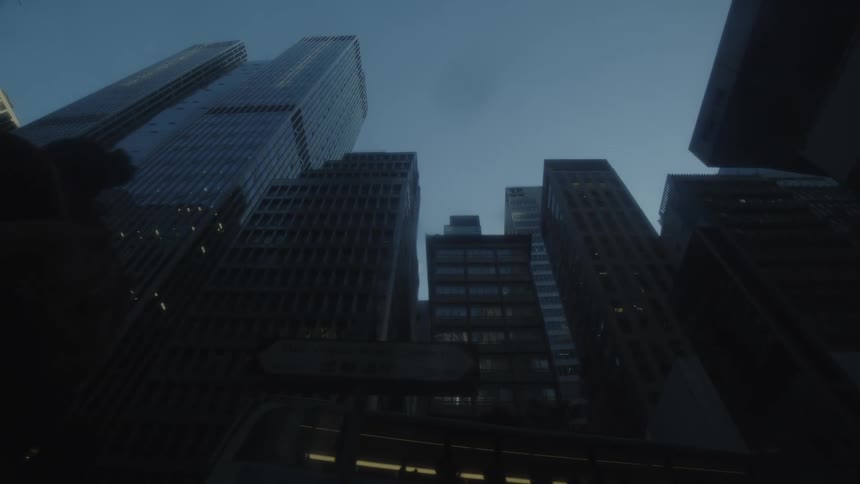 The camera is on the pavement in a big city pointing straight up as people walk past looking at the skyline