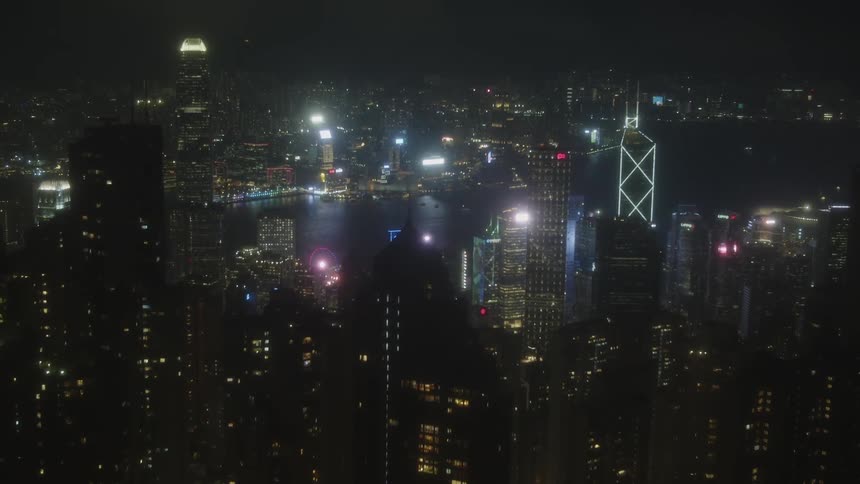 Aerial view of a city with illuminated skyscrapers at night