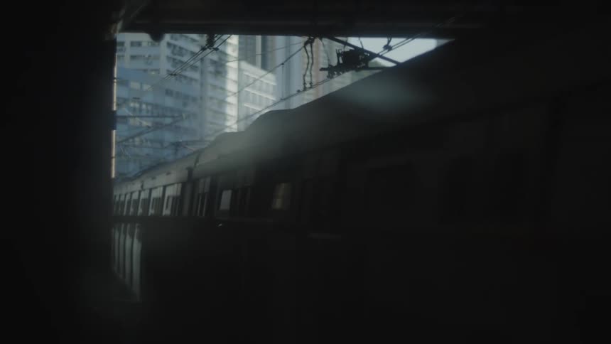 A train travels through a vibrant cityscape in an urban setting
