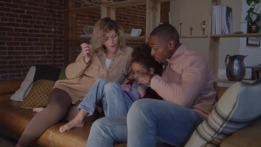 The family talk and point at a tablet