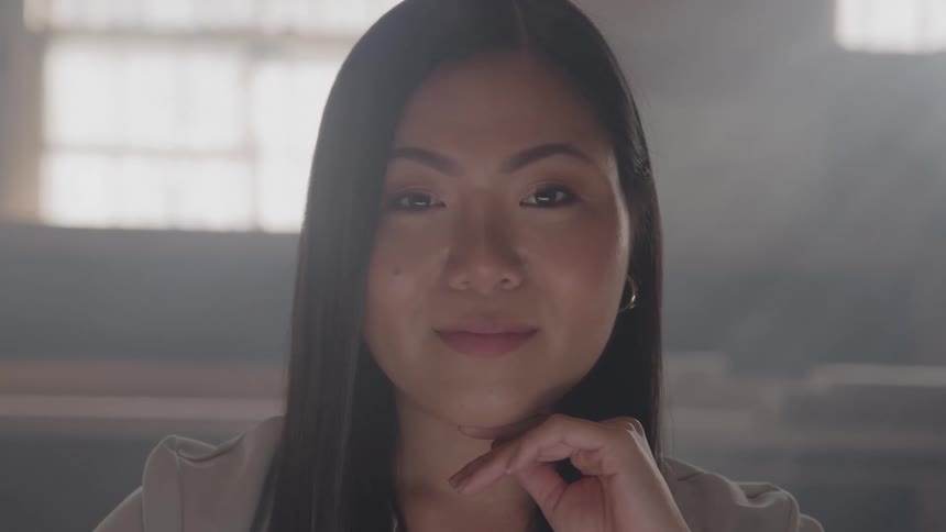 Close up portrait of a young asian woman in a room during daytime
