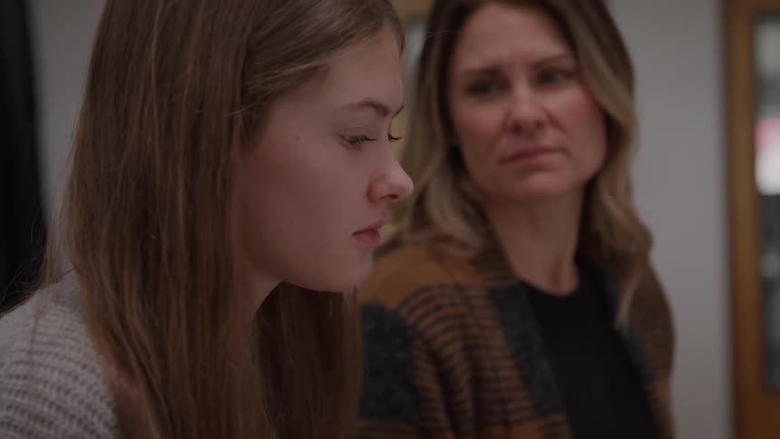 The mother and daughter look at each other looking sad