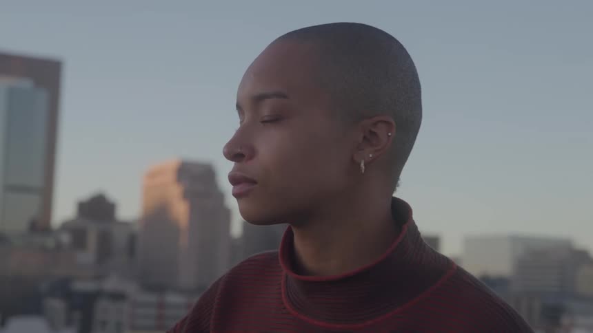 The woman looks out over the metropolis