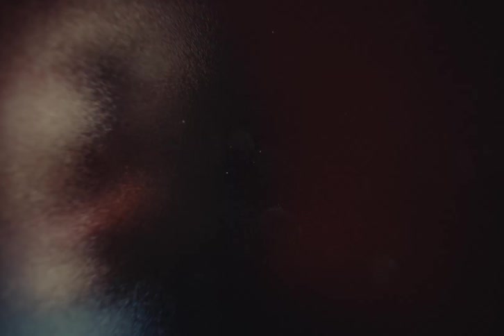 Close up of a young woman screaming behind a frosted glass