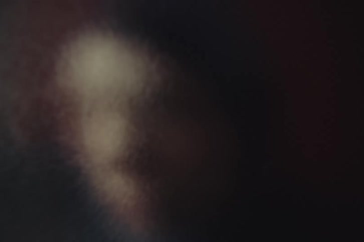 Close up of a young woman searching behind a frosted glass